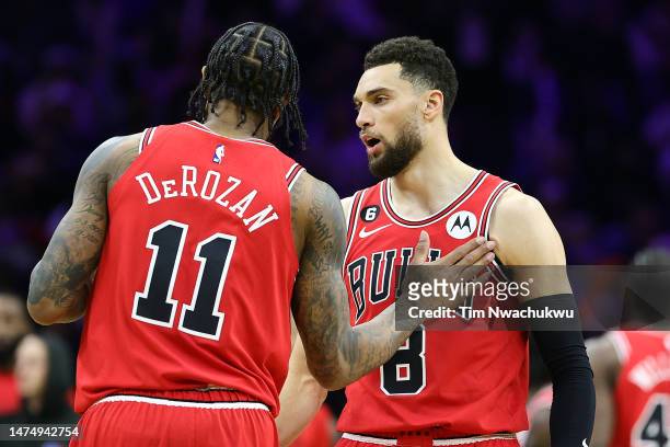 DeMar DeRozan and Zach LaVine of the Chicago Bulls speak during the fourth quarter against the Philadelphia 76ers at Wells Fargo Center on March 20,...