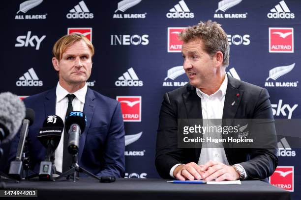 Newly announced All Blacks Coach Scott Robertson looks on as NZR CEO Mark Robinson speaks to the media during a New Zealand Rugby Press Conference at...