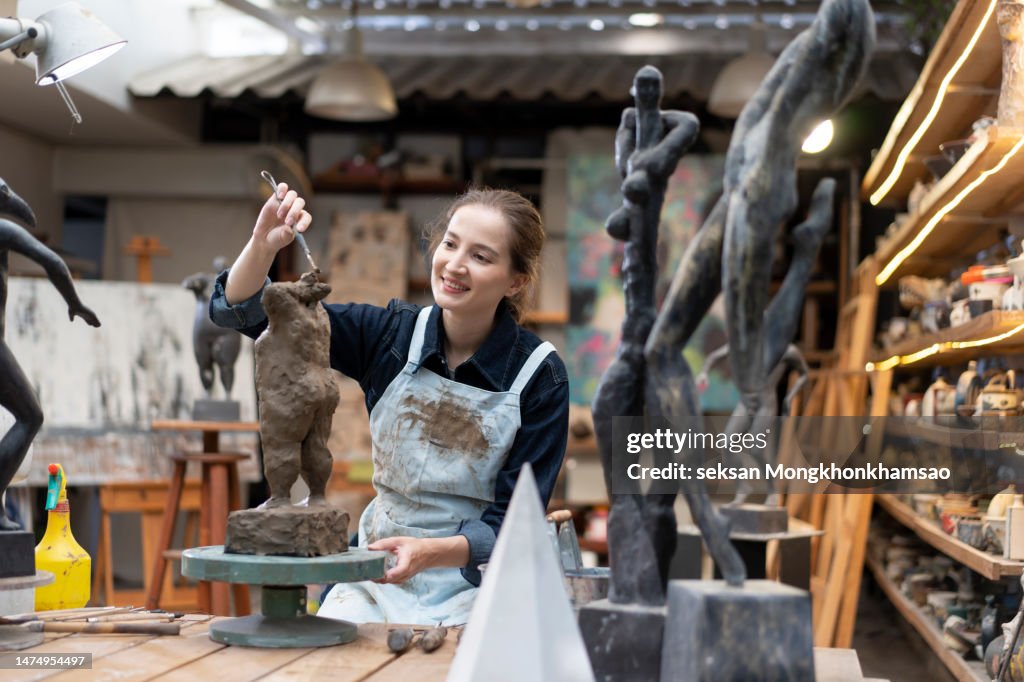 People making sculptures in art studio