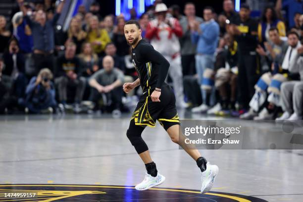 Stephen Curry of the Golden State Warriors runs back down court against the Phoenix Suns at Chase Center on March 13, 2023 in San Francisco,...