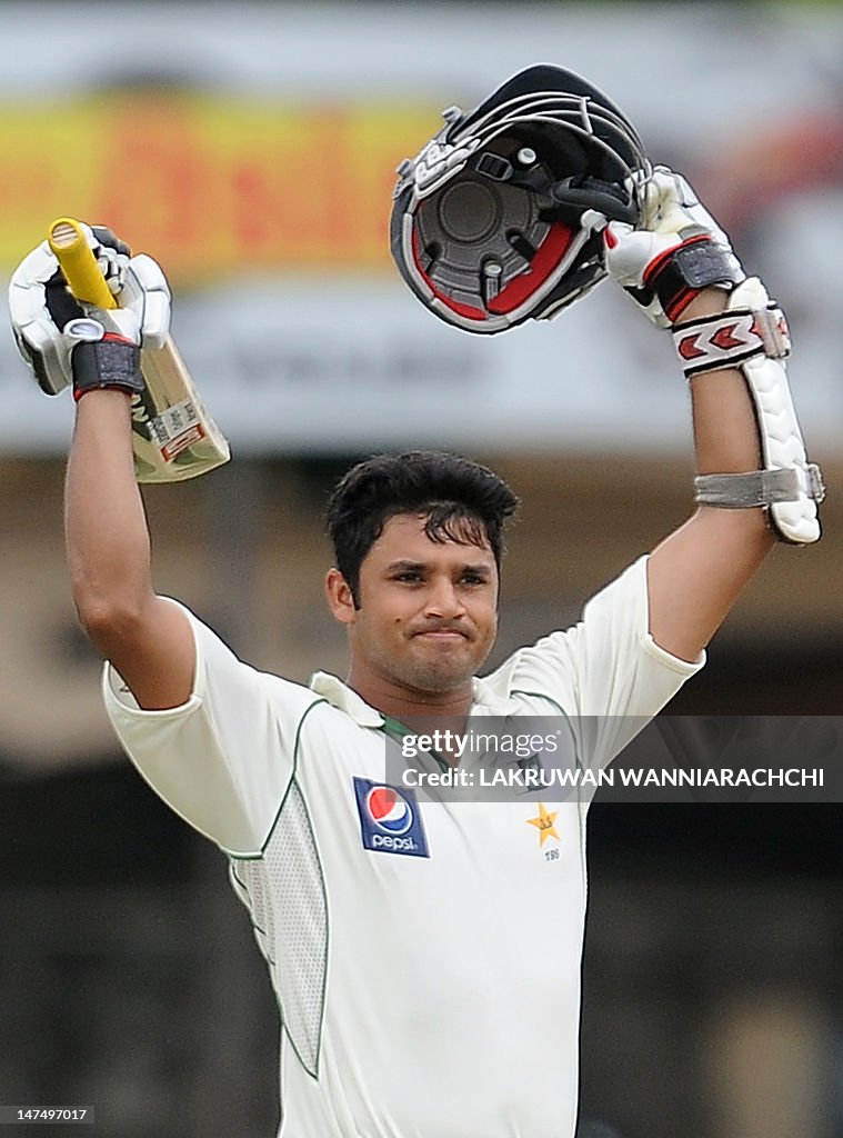 Azhar Ali Rind Pakistan cricketer Azhar Ali raises his bat and helmet in celebration ...