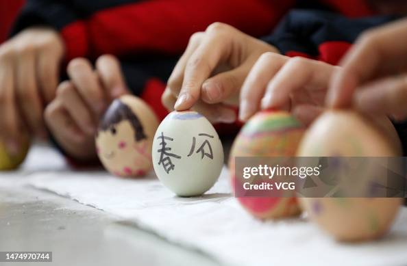 Spring Chunfen Children balance their eggs on end to mark Chunfen, or Spring Equinox ...