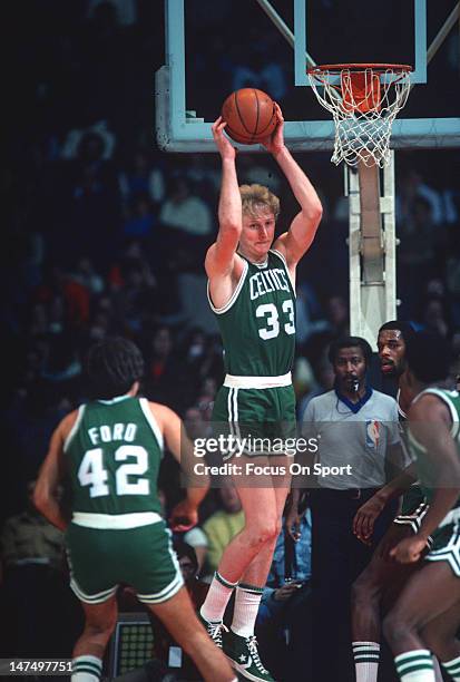 Larry Bird of the Boston Celtics pulls down a rebound against the Washington Bullets during an NBA basketball game circa 1985 at the Capital Center...
