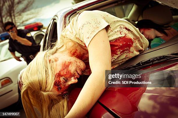 injured women in a car after accident with policeman responding - dead bodies in car accident photos stock pictures, royalty-free photos & images