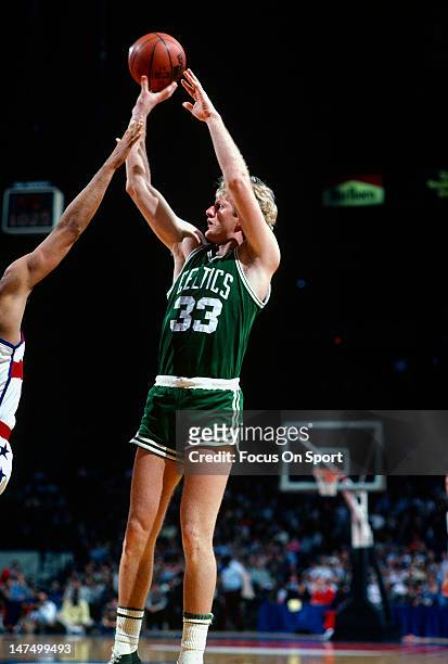 Larry Bird of the Boston Celtics shoots over Greg Ballard of the Washington Bullets during an NBA basketball game circa 1985 at the Capital Center in...