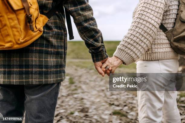 hold my hand and let's make it last - old couple holding hands stock pictures, royalty-free photos & images