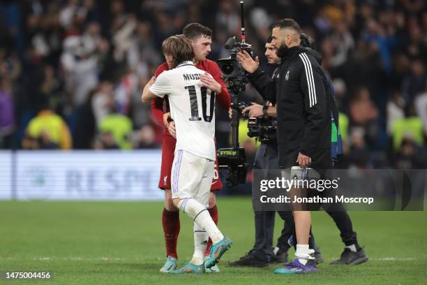 Karim Benzema of Real Madrid looks on as Andrew Robertson of Liverpool FC and Luka Modric of Real Madrid embrace following the final whistle of the...