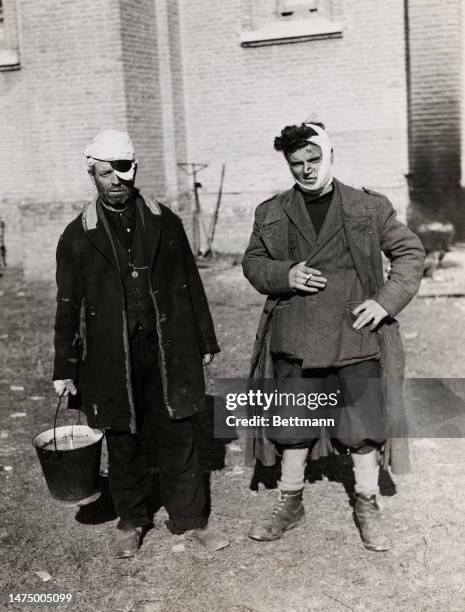 Father and son, both injured during German shelling of the Anzio-Nettuno beachhead area, await to be taken to Naples, circa 1944. The Allied military...