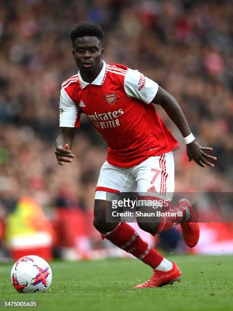 Bukayo Saka of Arsenal runs with the ball during the Premier League match between Arsenal FC and Crystal Palace at Emirates Stadium on March 19, 2023...