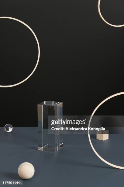 abstract minimal 3d scene showcase with geometric composition of levitated natural wooden circles, cube and glass prism and balls on dark gray and black background. - black cube stock pictures, royalty-free photos & images