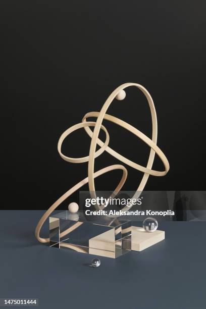 abstract minimal 3d scene showcase with geometric composition of levitated natural wooden circles and glass blocks and balls on dark gray and black background. - stillleben stock-fotos und bilder