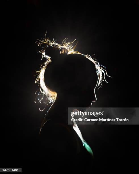 silhouette of young woman side view. - silhouette people back lit stock pictures, royalty-free photos & images