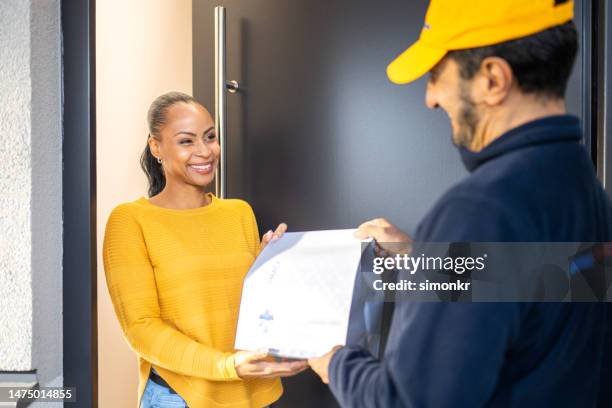 delivery person delivering medicine to woman - prescription home delivery stock pictures, royalty-free photos & images