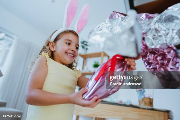 child girl holding chocolate easter egg - mammal egg stock pictures, royalty-free photos & images