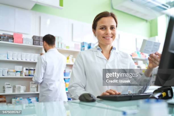 female pharmacist using computer - pharmacist stock pictures, royalty-free photos & images