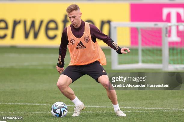 Joshua Kimmich of Germany plays the ball during a training session of the German national team at DFB-Campus on March 21, 2023 in Frankfurt am Main,...