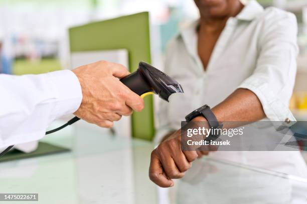 smart watch mobile payment - paying doctor stock pictures, royalty-free photos & images