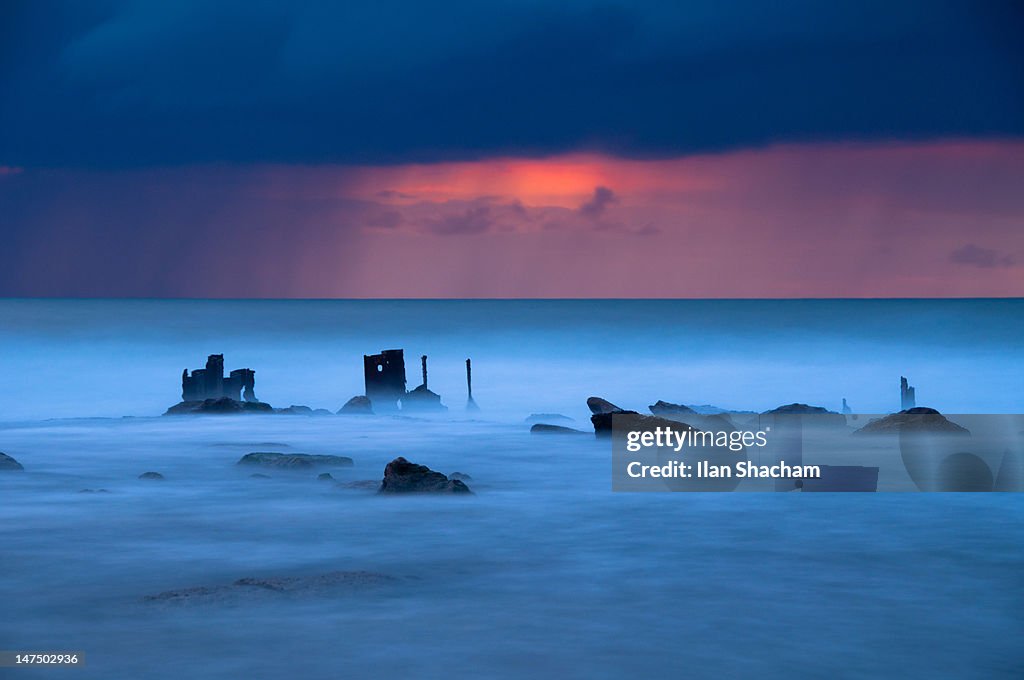 Haunting looking sea and wrecks at sunset