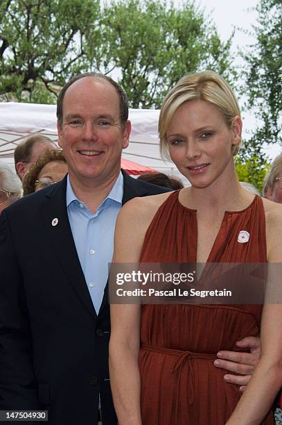 Prince Albert II of Monaco and Princess Charlene attend the annual Monaco Red Cross Pique-Nique at Jardins Princesse Antoinette on June 30, 2012 in...