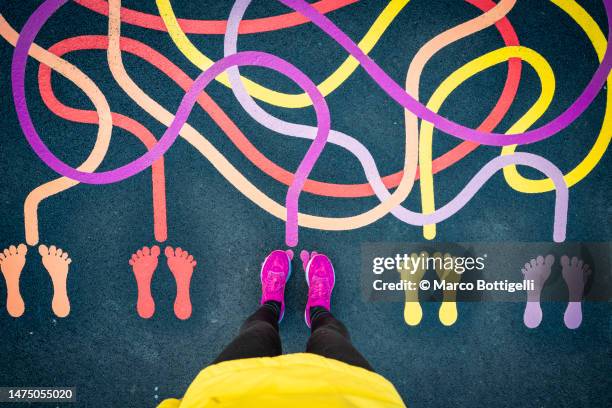 joyful person standing on a playground - coloured tarmac stock pictures, royalty-free photos & images