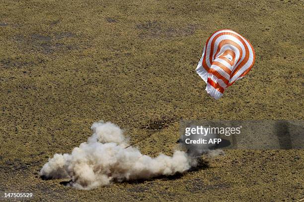The Soyuz TMA-03M capsule, carrying International Space Station crew members lands in a remote area near the town of Dzhezkazgan on July 1, 2012....