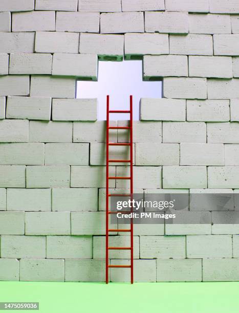 a way to escape - ladder to hole in block wall - breaking through wall stockfoto's en -beelden