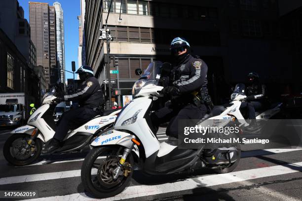 Officers drive past Trump Tower on March 21, 2023 in New York City. NYC and other cities are bracing for a possible indictment of former President...