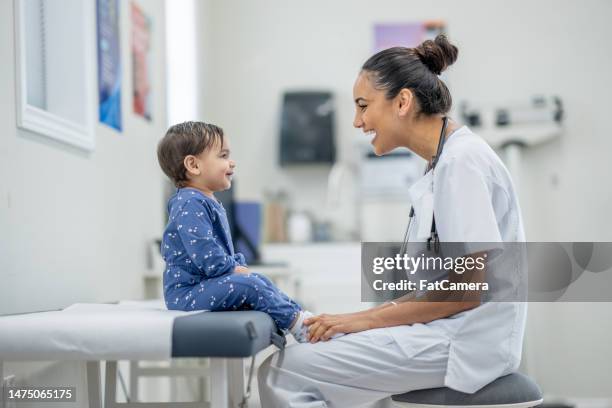 kleinkind bei einem check-up - doctor children stock-fotos und bilder