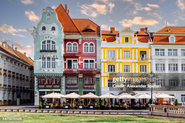 multi-colored houses at piata unirii (unity square) in timisoara, romania - european capital of culture stock pictures, royalty-free photos & images