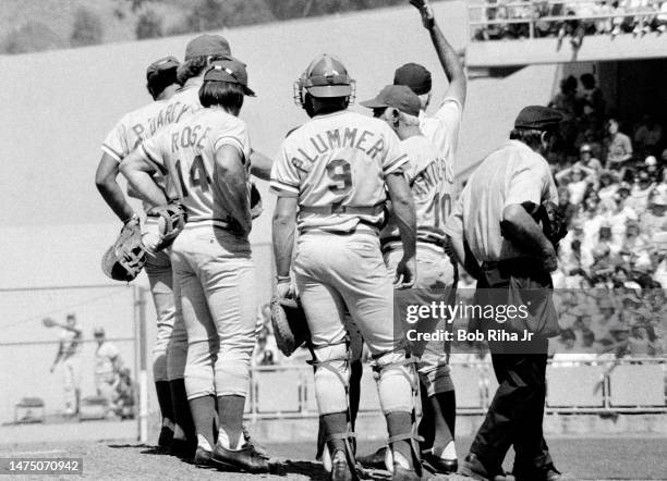 Cincinnati Reds Manager Sparky Anderson has umpire signal for a new pitcher as Pete Rose and teammates meet on pitchers mound during game between Los...