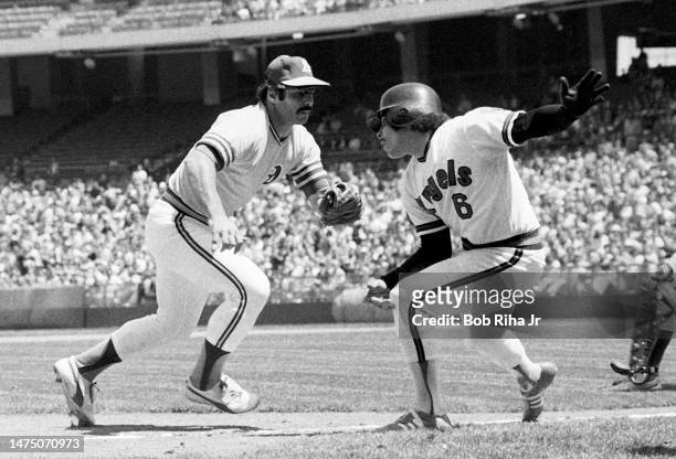 Oakland's Sal Bando prepares to tag out Angels Ellie Rodriguez during game between the California Angels and Oakland Athletics, April 27, 1975 in...