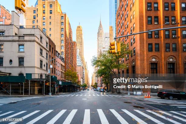 street in manhattan downtown with crysler building, new york city, usa - cityscape ストックフォトと画像