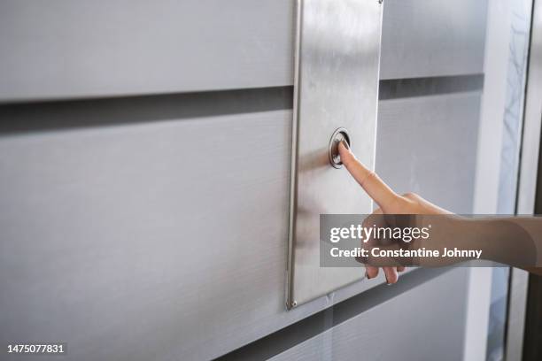 close up of woman hand pressing elevator button - hiss bildbanksfoton och bilder