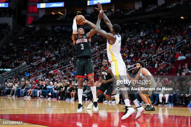 Kevin Porter Jr. #3 of the Houston Rockets shoots the ball over JaMychal Green of the Golden State Warriors during the game at Toyota Center on March...