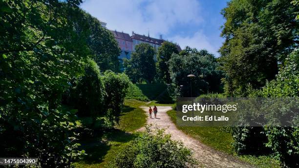 people in park area entrance to tallinn estonia old town - tallinn stock pictures, royalty-free photos & images