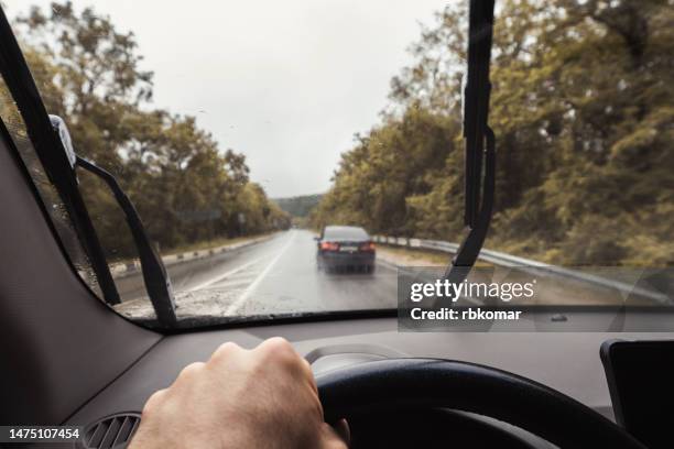 driving rain on the road - windschutzscheibe innen stock-fotos und bilder