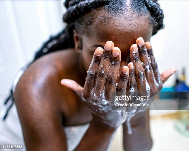 washing face - washing face stock pictures, royalty-free photos & images