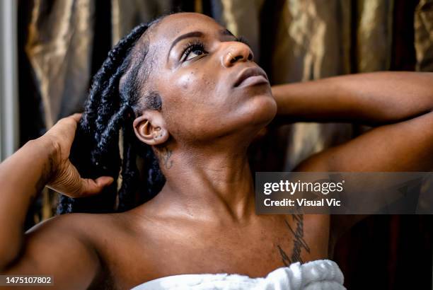 woman styling her own hair - braided hair stock pictures, royalty-free photos & images