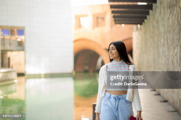young woman walking in the city - nuevo leon state stock pictures, royalty-free photos & images