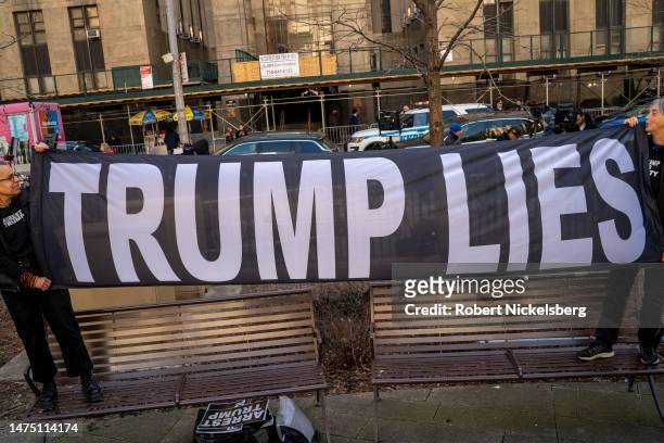 Trump critics gather outside of a Manhattan courthouse as the nation waits for the possibility of an indictment against former president Donald Trump...