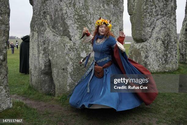 Dances between stones as Druids, Pagans and revellers gather at Stonehenge to mark the spring equinox on March 21, 2023 in Amesbury, England. Around...