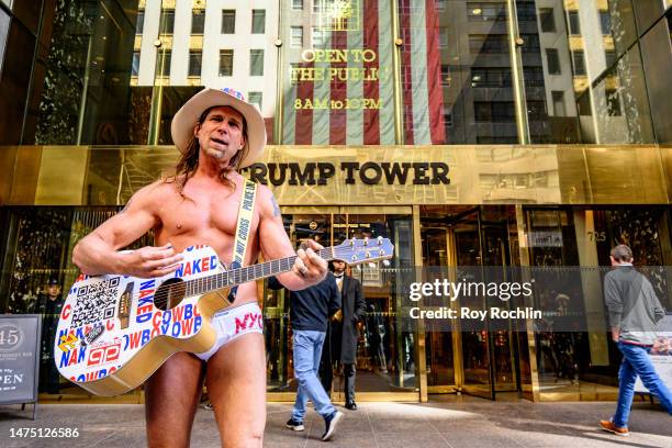 Robert John Burck, aka The Naked Cowboy plays outside of the Trump Tower on 5th Ave. On March 21, 2023 in New York City.