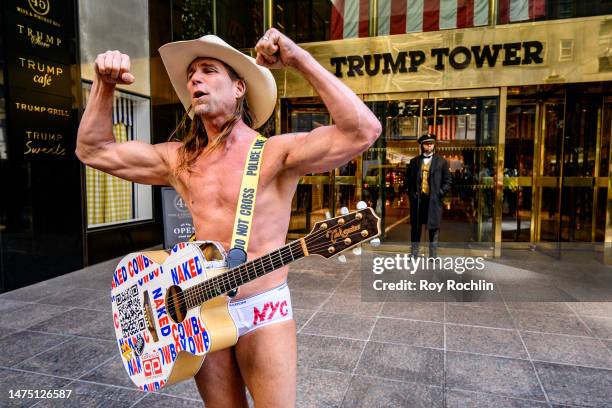 Robert John Burck, aka The Naked Cowboy plays outside of the Trump Tower on 5th Ave. On March 21, 2023 in New York City.