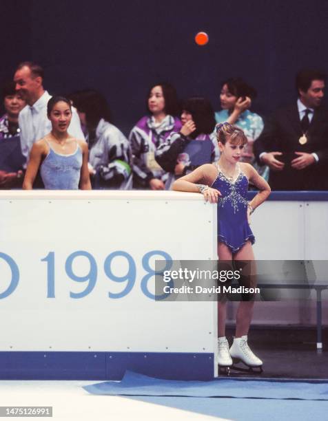 Tara Lipinski and Michelle Kwan of the United States wait to skate in the Free Skate event of the Ladies Singles figure skating competition at the...