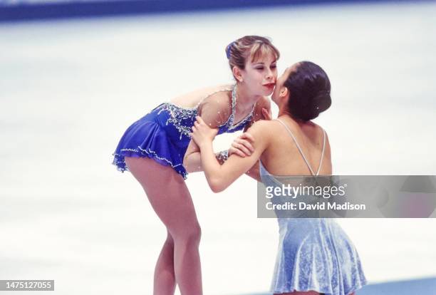 Tara Lipinski and Michelle Kwan take part in the awards ceremony for the Ladies Singles event of the figure skating competition in the 1998 Winter...