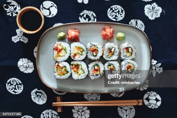 table top view of sushi rolls on the plate with soy sauce and chopsticks - pickled ginger stock pictures, royalty-free photos & images