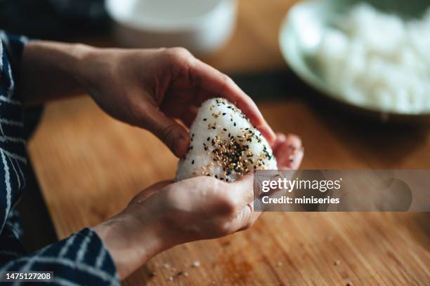 close up photo of woman hands preparing onigiri at home - rice ball stock pictures, royalty-free photos & images
