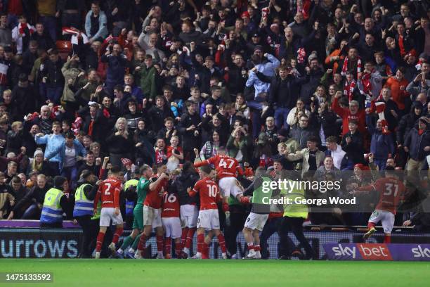 Liam Kitching of Barnsley celebrates with teammates and the fans after scoring the team's fourth goal during the Sky Bet League One between Barnsley...