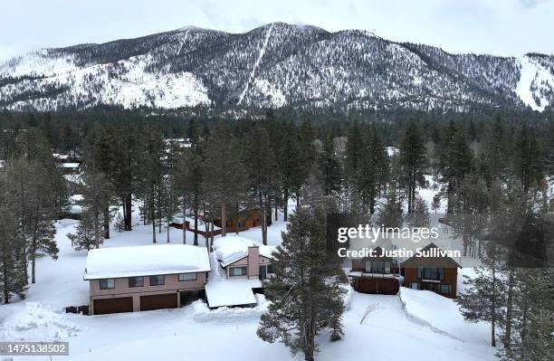 In an aerial view, homes are seen covered in snow on March 21, 2023 in South Lake Tahoe, California. As a 12th atmospheric river hits California, the...