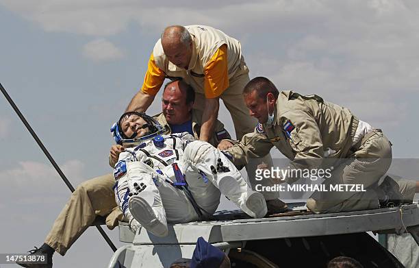 Support and medical personnel carry International Space Station crew member, Expedition 31 Commander, and Russian cosmonaut Oleg Kononenko shortly...